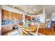 Cozy kitchen/dining area featuring custom wood cabinetry and a desk at 1738 Edgewater Pl, Longmont, CO 80504