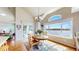 Sunlit dining area with large windows overlooking the lake and patio access at 1738 Edgewater Pl, Longmont, CO 80504