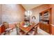 Formal dining room with chandelier lighting, decorative wallpaper, and wood furniture at 1738 Edgewater Pl, Longmont, CO 80504