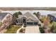 Well-manicured front lawn with large front porch and three car garage at 1738 Edgewater Pl, Longmont, CO 80504