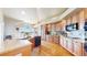 Spacious kitchen with wood floors, island, granite countertops, and stainless steel appliances at 1738 Edgewater Pl, Longmont, CO 80504