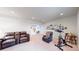 Spacious living room featuring a lounge suite and exercise bike, perfect for relaxation and fitness at 1738 Edgewater Pl, Longmont, CO 80504