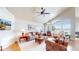 Bright living room with vaulted ceilings, large windows, and ceiling fan at 1738 Edgewater Pl, Longmont, CO 80504
