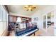 Music room with grand piano, built-in bookshelves, and ample natural light at 1738 Edgewater Pl, Longmont, CO 80504