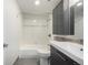 Bright bathroom featuring a shower-tub combo and sleek vanity at 7665 E Eastman Ave # 202A, Denver, CO 80231