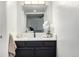 Updated bathroom featuring a granite countertop and a sleek, modern mirror at 7665 E Eastman Ave # 202A, Denver, CO 80231