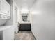 Bathroom with modern fixtures, tiled floor, stacked washer and dryer and ample vanity space at 7665 E Eastman Ave # 202A, Denver, CO 80231