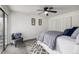 Bright bedroom featuring a ceiling fan, closet and sliding glass doors to a balcony at 7665 E Eastman Ave # 202A, Denver, CO 80231