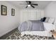 Cozy bedroom featuring a geometric rug, ceiling fan, and ample natural light at 7665 E Eastman Ave # 202A, Denver, CO 80231