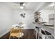 Dining area with modern decor, ceiling fan and adjacent breakfast bar seating at 7665 E Eastman Ave # 202A, Denver, CO 80231