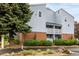 Building exterior features brick accents, private balconies, beautiful landscaping, and a welcoming ambiance at 7665 E Eastman Ave # 202A, Denver, CO 80231