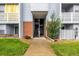 Building exterior with private entrances and balconies, complemented by green space and a tidy walkway at 7665 E Eastman Ave # 202A, Denver, CO 80231