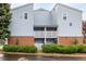 Building exterior showcasing multiple units, private balconies, and brick facade, creating an inviting curb appeal at 7665 E Eastman Ave # 202A, Denver, CO 80231
