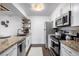 Modern kitchen with stainless appliances, granite counters, and stylish white cabinets at 7665 E Eastman Ave # 202A, Denver, CO 80231