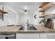 Kitchen island features granite countertops, stainless sink, breakfast bar and open shelving at 7665 E Eastman Ave # 202A, Denver, CO 80231
