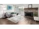 Living room showcases a comfortable gray sofa, stylish rug, and a cozy fireplace at 7665 E Eastman Ave # 202A, Denver, CO 80231