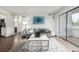 Bright living room with gray sofa, eye-catching artwork, and access to outdoor patio at 7665 E Eastman Ave # 202A, Denver, CO 80231