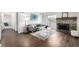 Inviting living room with hardwood floors, a stone fireplace, and a cozy seating area at 7665 E Eastman Ave # 202A, Denver, CO 80231