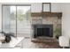 Living room features a stone fireplace, wood mantle, sliding door to patio at 7665 E Eastman Ave # 202A, Denver, CO 80231