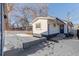 Small backyard with a snow covered patio and raised garden beds at 3756 Decatur St, Denver, CO 80211