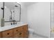 Bathroom with wood vanity, marble countertop, and stylish fixtures at 3756 Decatur St, Denver, CO 80211