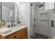 Updated bathroom features a walk-in shower and a wood vanity with a marble top at 3756 Decatur St, Denver, CO 80211