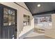 Inviting front porch with a gray door and white picket fence at 3756 Decatur St, Denver, CO 80211