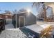 Detached garage with gray exterior and small garden bed at 3756 Decatur St, Denver, CO 80211