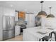 Updated kitchen, featuring stainless steel appliances and white cabinets at 3756 Decatur St, Denver, CO 80211