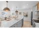 Open kitchen with white cabinets, island, and stainless steel appliances at 3756 Decatur St, Denver, CO 80211