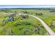 Expansive aerial view of a home surrounded by green meadows and scattered trees, showcasing a serene countryside setting at 3163 Windstream Ln, Elizabeth, CO 80107
