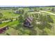 Stunning aerial view of a home with a large lot, mature trees, and a deck for outdoor enjoyment at 3163 Windstream Ln, Elizabeth, CO 80107
