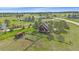 Aerial shot of a charming home with a deck, shed, and fenced yard, nestled amidst lush greenery and mature trees at 3163 Windstream Ln, Elizabeth, CO 80107