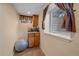 Cozy basement nook featuring a window view and a beverage center, complete with cabinets and counter space at 3163 Windstream Ln, Elizabeth, CO 80107