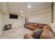 Spacious basement area with a comfortable seating, a pellet stove and a TV at 3163 Windstream Ln, Elizabeth, CO 80107