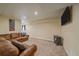 Cozy basement area with a leather sofa, window, and pellet stove, perfect for relaxing and entertaining at 3163 Windstream Ln, Elizabeth, CO 80107