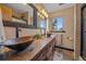 Dual copper vessel sinks atop a wood vanity complement the modern bathroom design at 3163 Windstream Ln, Elizabeth, CO 80107