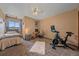 Bedroom with exercise equipment and workspace, lit by a ceiling fan and natural light from a window at 3163 Windstream Ln, Elizabeth, CO 80107