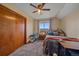 Cozy bedroom features a closet with wood doors, window view, and ceiling fan at 3163 Windstream Ln, Elizabeth, CO 80107