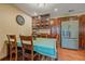 Classic dining room features a table with seating, hardwood floors, and built-in wooden cabinetry at 3163 Windstream Ln, Elizabeth, CO 80107