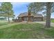 Inviting home with a deck and a well-manicured lawn, accented by mature trees, enhancing its curb appeal at 3163 Windstream Ln, Elizabeth, CO 80107
