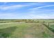 Expansive green land with wooden fence and open field creating a serene and peaceful atmosphere at 3163 Windstream Ln, Elizabeth, CO 80107