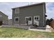 Back exterior of the home featuring a deck and sliding glass doors, enhancing outdoor living at 317 Whimsical Ave, Brighton, CO 80603