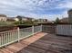 Spacious wooden deck overlooks a grassy yard with neighborhood homes visible in the distance at 317 Whimsical Ave, Brighton, CO 80603