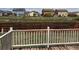 View from the wooden deck overlooking a grassy yard and neighborhood at 317 Whimsical Ave, Brighton, CO 80603