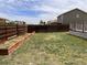 Backyard featuring a grassy area and wood fence, providing a private outdoor space at 317 Whimsical Ave, Brighton, CO 80603