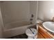 Standard bathroom with a tiled bathtub, toilet, and sink area, ready for personalization at 317 Whimsical Ave, Brighton, CO 80603