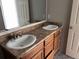Bathroom featuring a double sink vanity with modern faucets and neutral countertops at 317 Whimsical Ave, Brighton, CO 80603