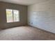 Bedroom shows a view to the outside deck and a decorative wall awaiting your personal touches at 317 Whimsical Ave, Brighton, CO 80603