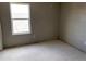 This is a bedroom with a window looking out onto the roof of another house at 317 Whimsical Ave, Brighton, CO 80603